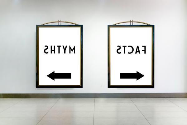 Two signs on a wall, one says Facts and points to the left, the other says Myths and points to the right